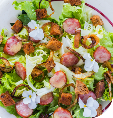 A salad with sliced Montbéliard sausages